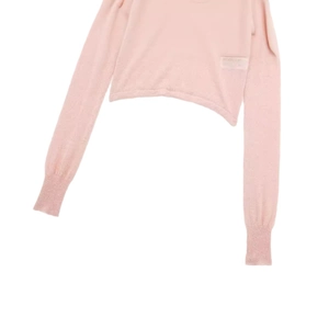 Soft pink long sleeve knit sweater with ribbed cuffs and decorative brand label tag