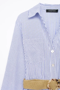 Close-up of blue striped shirt dress with a woven belt and pearl buttons detail