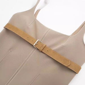 Khaki sleeveless dress featuring decorative white topstitching and a brown buckled belt