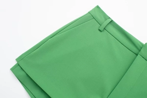 Detailed close-up of grass green high-waist trousers showing side pocket and fine stitching