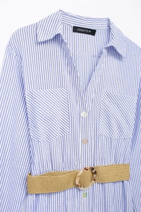 Detail of blue striped shirt dress with double pockets and a woven belt with round buckle
