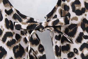 Close-up of lightweight leopard print fabric featuring a delicate bow tie detail at the back