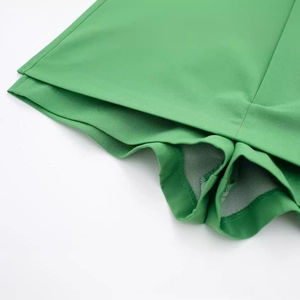 Women's minimalist grass green skort with built-in mesh liner and elastic fabric