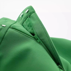 Women's chic vibrant green skort with zipper closure and dual metal hooks waist detail