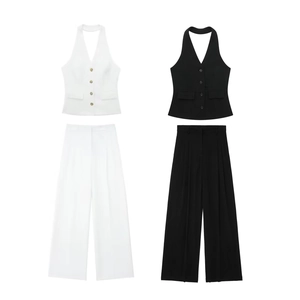 Flat lay of white and black two-piece suits with halter vests and wide-leg trousers