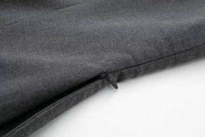 Close-up of high-quality black invisible zipper and dark charcoal twill fabric on top