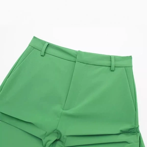 Women's minimalist high-waisted green skort featuring a clean waistline with belt loops