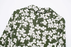 Detail of dark green floral chiffon dress showing the collar and fabric texture