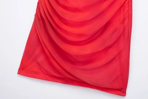Detail view of the red mesh fabric featuring elegant draped pleated textures for women
