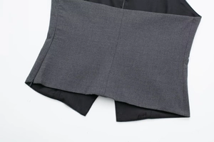Close-up of grey fabric texture and side invisible zipper detail on a halter top