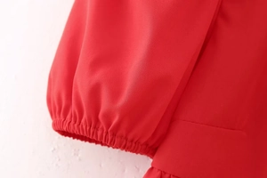 Detailed macro shot of red elastic puff sleeve cuffs with fine woven fabric texture