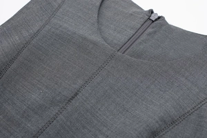 Close-up of dark grey skater dress showing textured fabric, stitching and hidden zipper