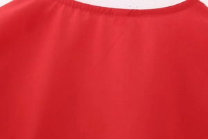 Close-up of the round neckline and smooth woven fabric texture of a red women top