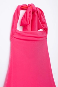 Detail of hot pink halter neck mesh dress with fine knitted texture and tie closure