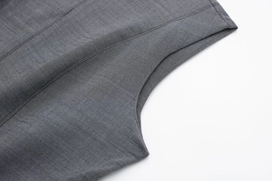 Close-up of the neat stitching and textured grey fabric on a skater dress armhole