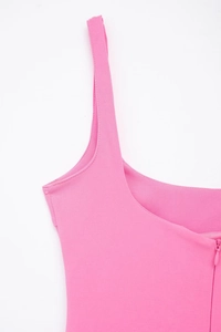 Detail of pink dress featuring a square neckline and a concealed back zipper