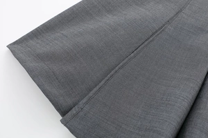 Macro detail of high-quality grey textured fabric stitching on professional skater dress