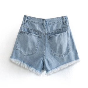 Close-up back view of light blue high waist denim shorts with frayed edges and pockets