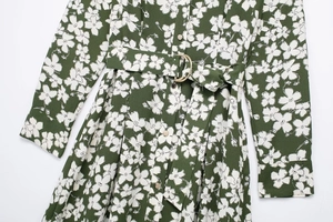 Detail of floral print shirt dress with army green fabric and gold circle waist buckle