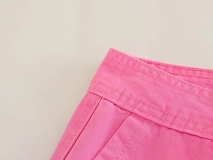 Close-up of pink cargo pants waist showing double-stitched cotton twill fabric