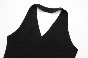 Detailed view of black halter V-neck top with pleated fabric and clean stitching