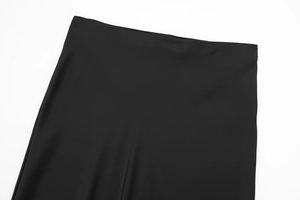 Detail view of smooth satin midi skirt waistline with seamless minimalist finish