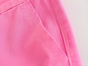 Detailed close-up of the double-needle stitching and pink twill cotton fabric on cargo pants