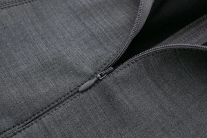Close-up of the high-quality invisible zipper and dark grey textured fabric of the skater dress