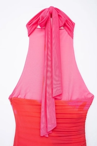 Detail of halter neck mesh dress featuring pink and orange gradient with ruched fabric