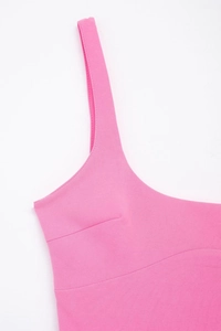Detail of rose pink dress showing high-quality stitching and ribbed knit fabric texture