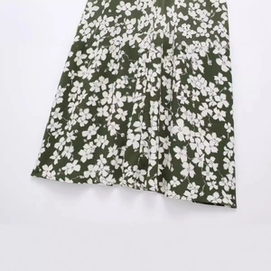 Olive green floral print dress featuring a tiered ruffled hem and flowy A-line silhouette