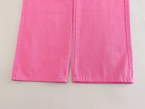 Detailed close-up of double-needle stitching on the hem of bright pink cargo pants