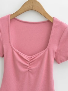 Detail of pink ribbed short sleeve tee with square neck and ruched chest pleats