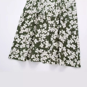 Dark green floral A-line midi skirt with white flower pattern on lightweight fabric