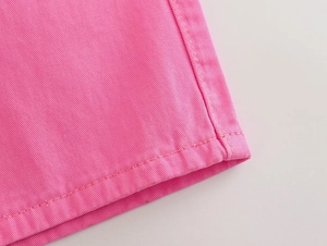 Detail of pink cotton denim fabric featuring high-quality double stitching and twill texture