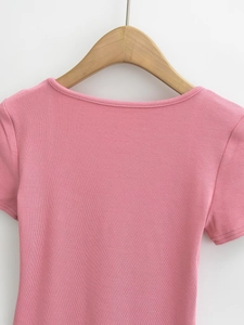 Detail shot of the ribbed texture and collar on a pink square neck short sleeve tee