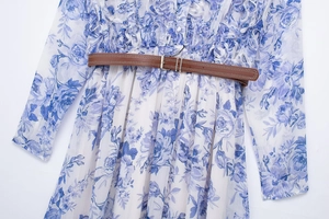 Detail of floral print summer dress featuring ruffled bodice and slim brown belt