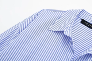 Detailed view of the striped poplin shirt collar with high-quality woven fabric texture