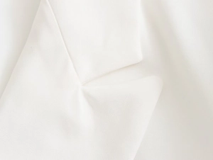 Detailed close-up showing the premium twill texture and white lapel stitching of the blazer