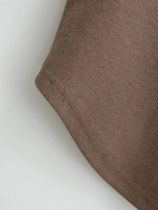 Close-up of coffee brown ribbed knit fabric with double-needle flat stitching detail