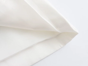 Close-up of white twill fabric texture and professional double-stitch sewing detail