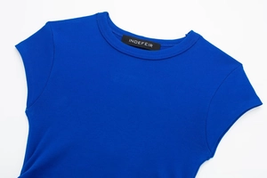 Detail of a bright blue ribbed knit crew neck top featuring a high-quality neckline texture