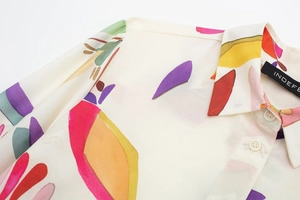 Detail of colorful abstract print poplin shirt with lapel collar and pearl buttons