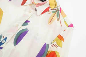 Detailed view of women's floral poplin shirt with sharp collar and abstract print