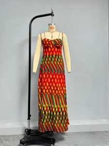 Detail of summer slip dress featuring geometric print with red and yellow ethnic patterns