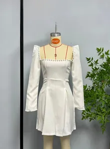 Detail of square neckline with white pearls on a long-sleeved A-line dress