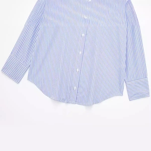 Modern blue and white striped poplin shirt with a curved hem and buttoned front