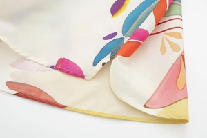 Detailed close-up of colorful abstract floral print on premium white poplin fabric set