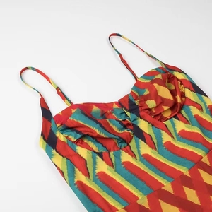 Summer spaghetti strap dress featuring vibrant red and yellow abstract brushstroke patterns