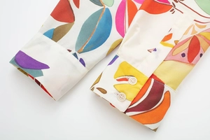 Detail of shirt cuffs with multi-color abstract floral print and double button closure